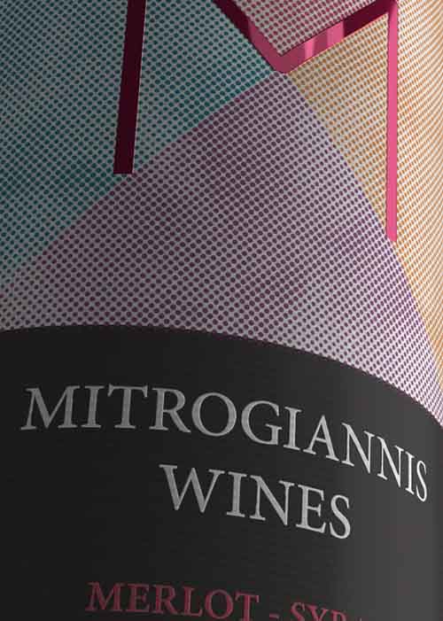 Close-up of red wine bottle sticker label showcasing elegant design elements and decorative details. NO IDEA. Branding Graphic Design Agency.