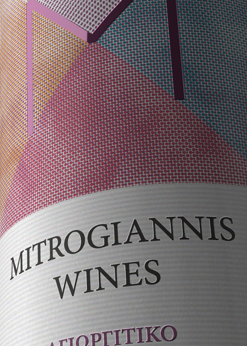 Close-up detail of custom rosé wine adhesive label showcasing fine printing and brand identity. NO IDEA. Branding Graphic Design Agency.