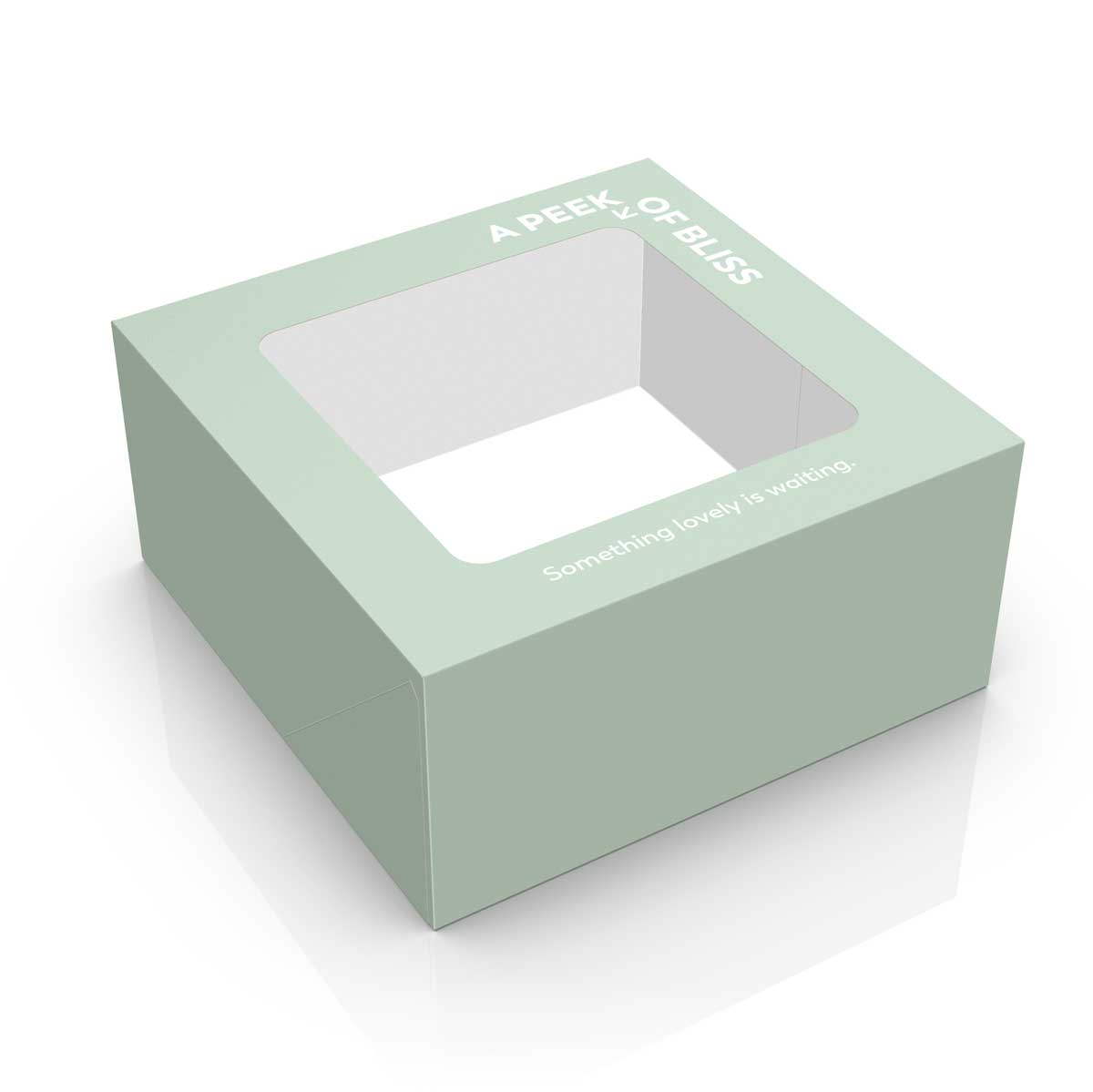 Green pastry box design with window die cut, typographic message and soft pastel colors. NO IDEA Branding Graphic Design Agency
