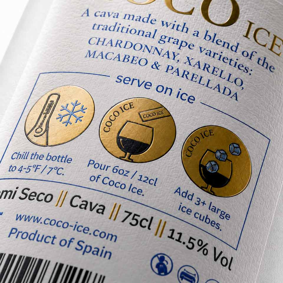 Detailed back view of bottle with sparkling wine label, serving instructions, barcode and mandatory regulatory information. NO IDEA Branding Graphic Design Agency
