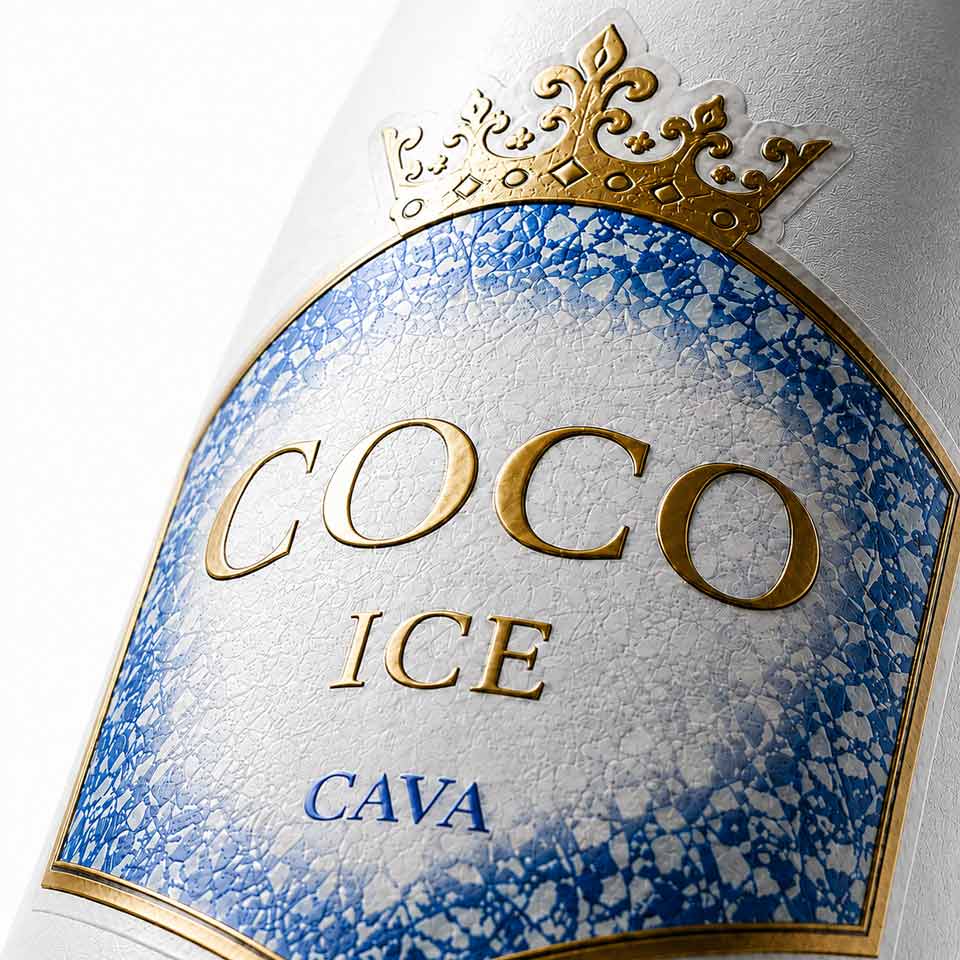 Close-up of sparkling wine front label with custom die-cut shape, embossing and gold finish. NO IDEA Branding Graphic Design Agency