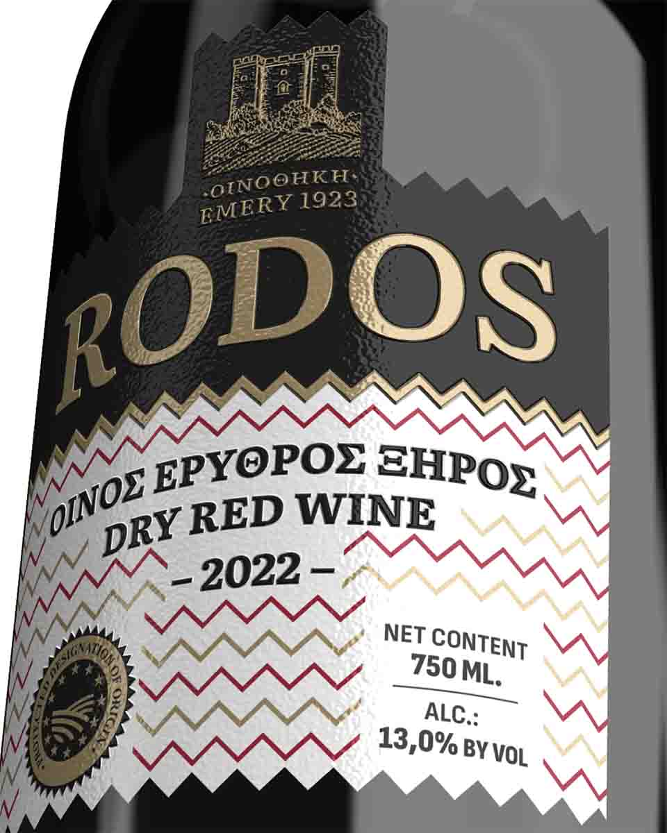 Close-up detail of red wine bottle label with Rhodes architectural motifs. NO IDEA. Branding Graphic Design Agency.
